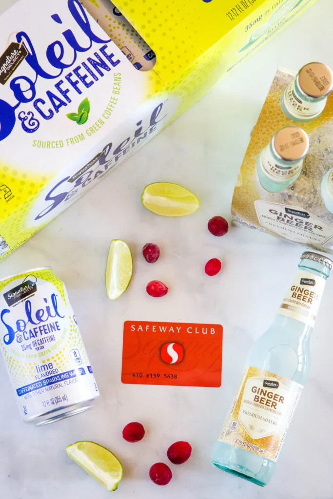 safeway club card with ginger beer, sparkling water, cranberries and lime slices