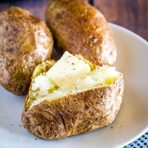 cropped image of potato with butter on it