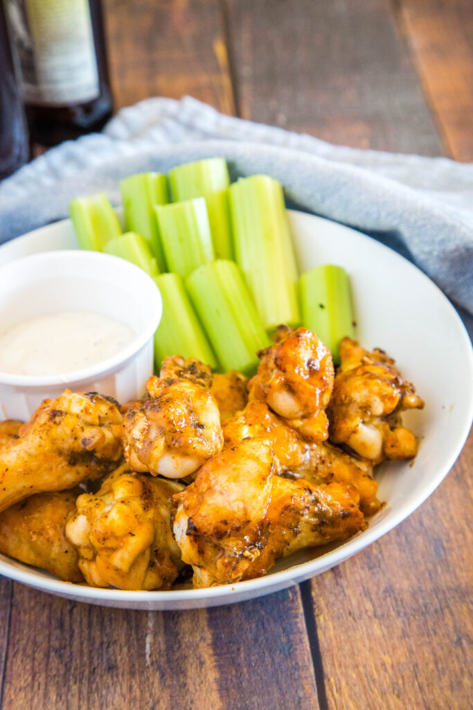 chicken wings tossed with buffalo sauce on a plate