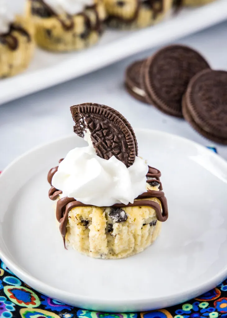 looking down on a mini oreo cheesecake topped with whipped cream