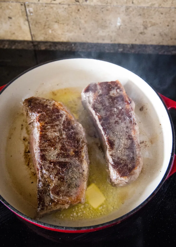 steak in skillet on stove