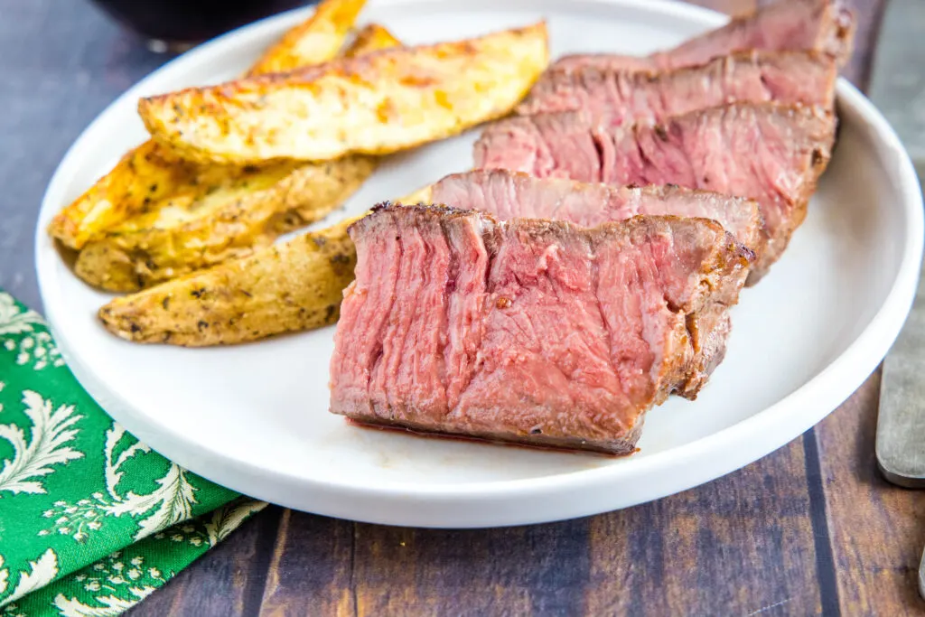 sliced sous vide steak on plate