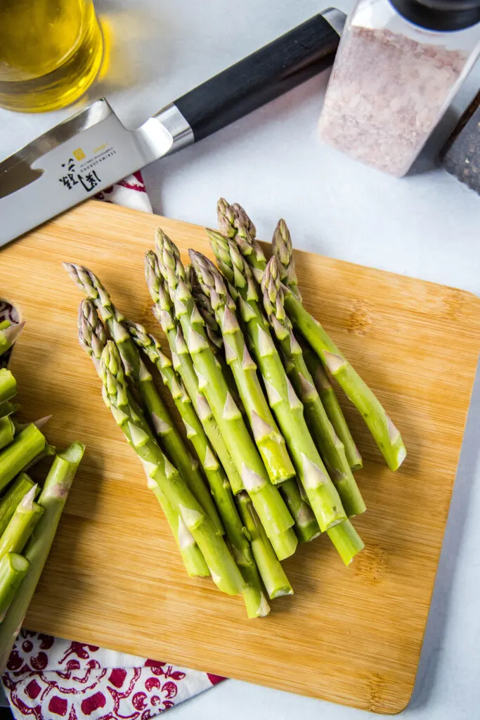 chopped asparagus on a cutting board