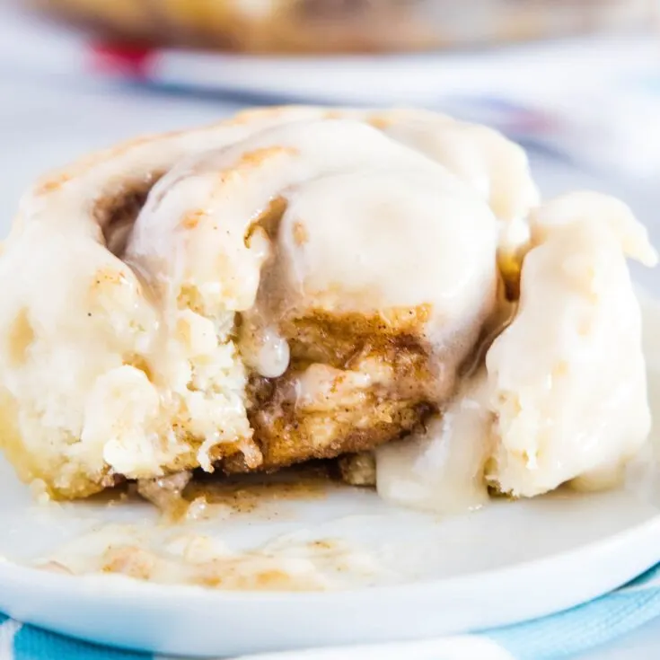 close up of cinnamon roll with bite missing