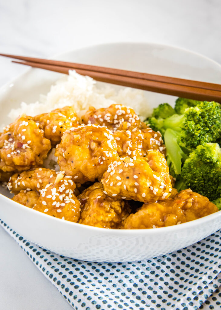 sesame chicken with broccoli in a bowl