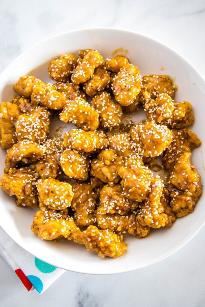 cooked sesame chicken on a white plate