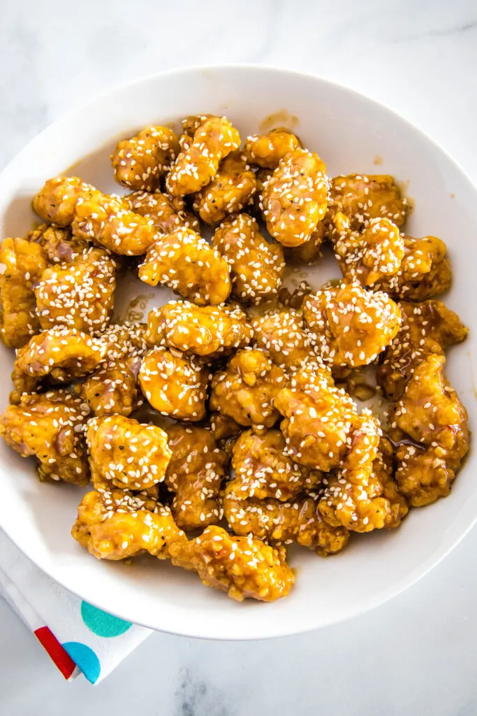 cooked sesame chicken on a white plate