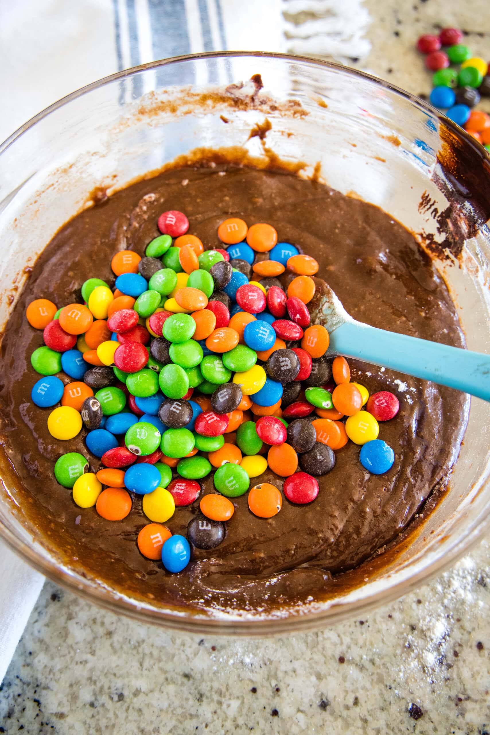 adding M&Ms to brownie batter