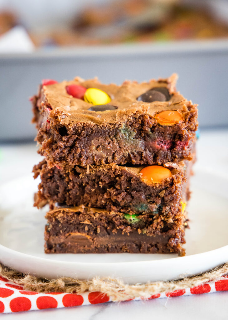 brownies with M&ms stacked on a plate