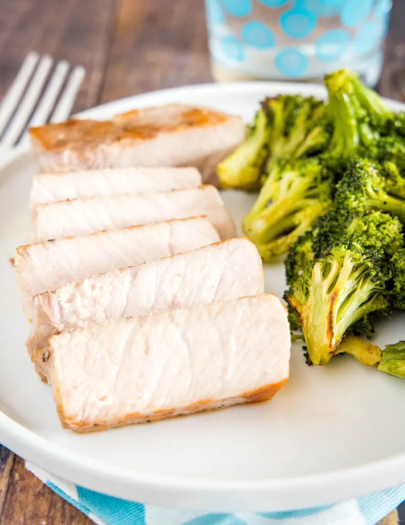 sous vide pork chops on plate with broccoli