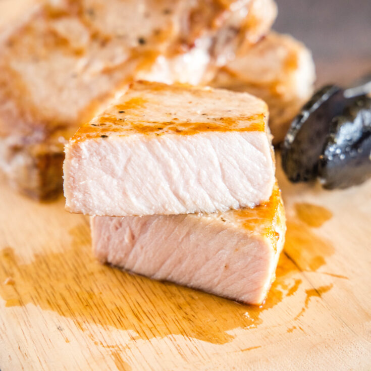 cropped picture of pork chop on cutting board