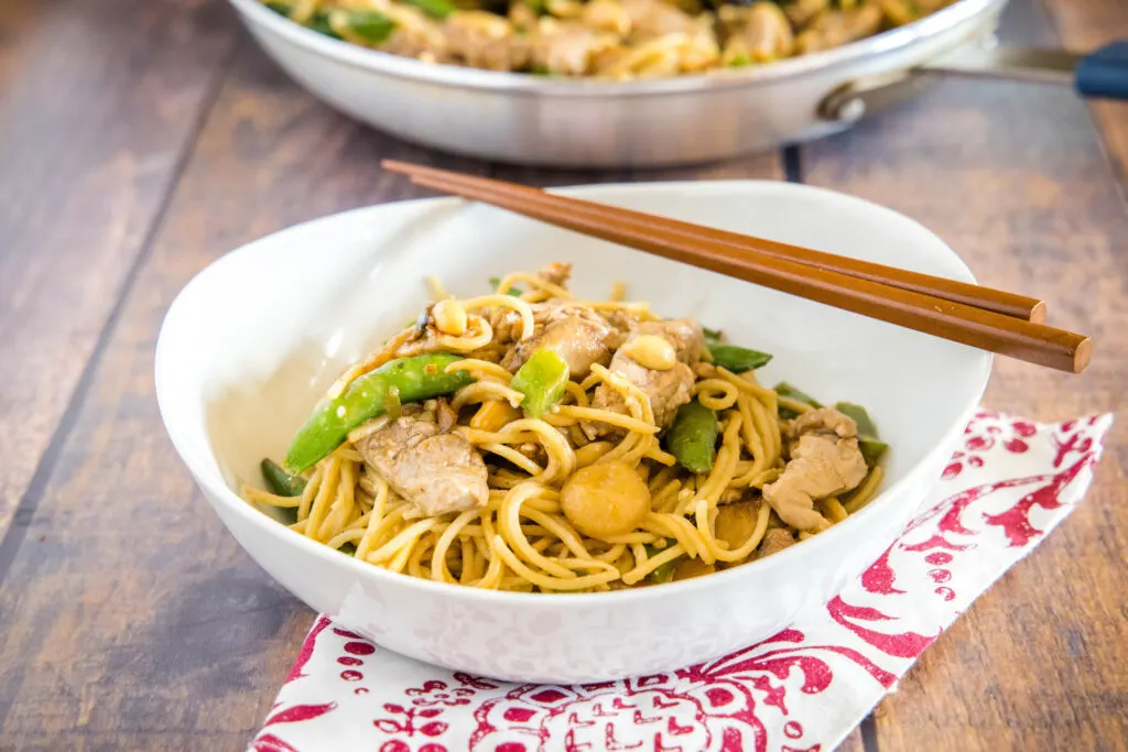 Stir Fry Noodles - Quick and easy Asian Noodles tossed with veggies, your favorite protein (I used pork) and a delicious peanut sauce that has just a little kick.