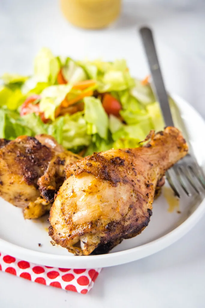 chicken drumsticks on a white plate