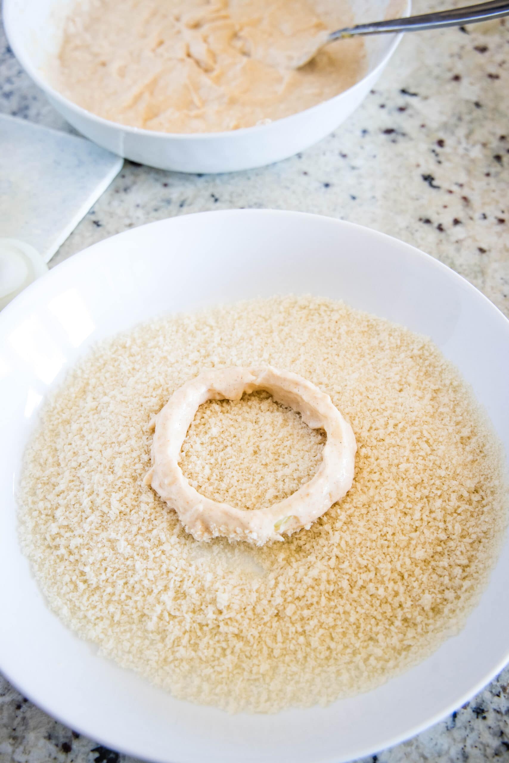 onion ring sitting in bowl of panko breadcrumbs