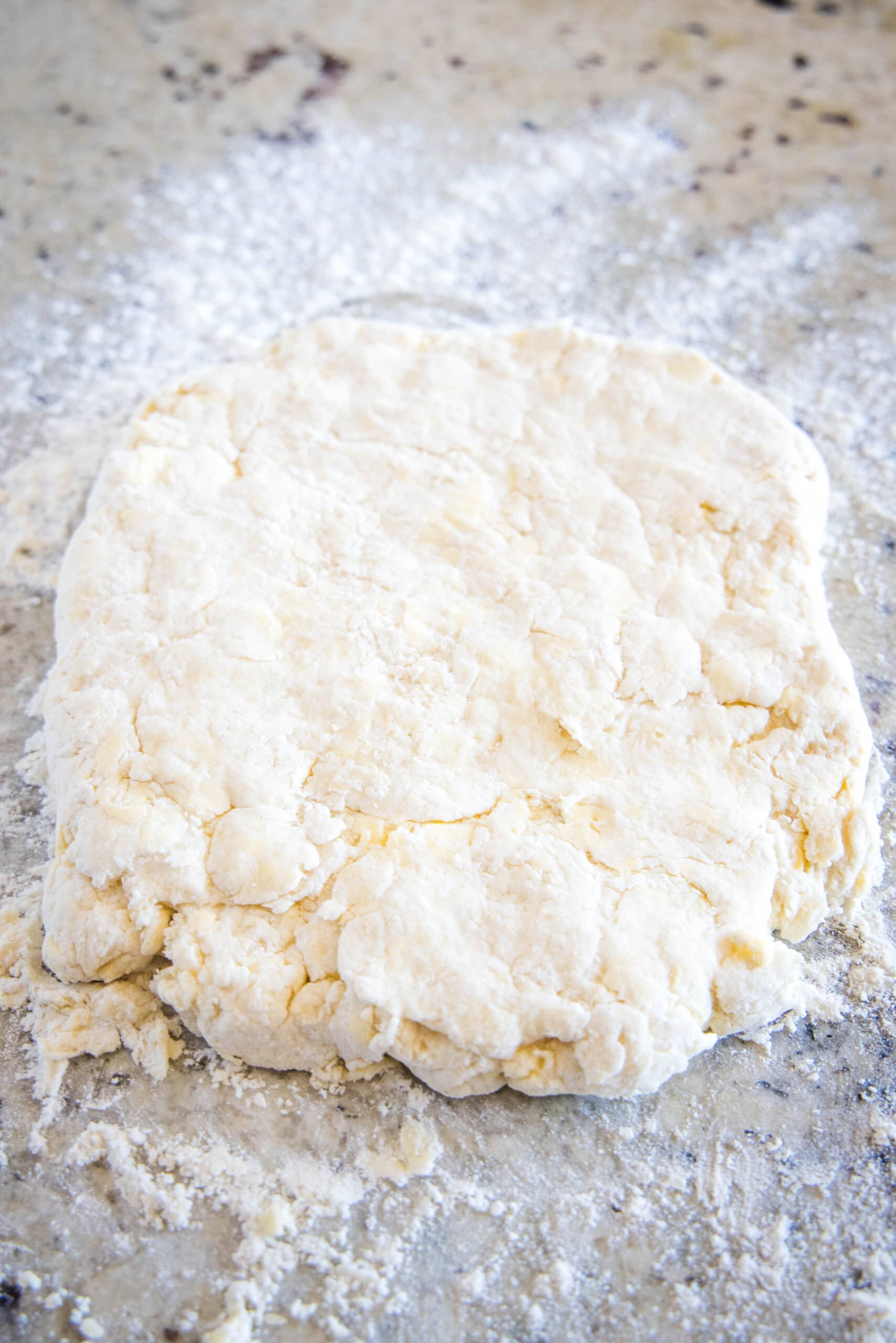 biscuit dough rolled out on the counter