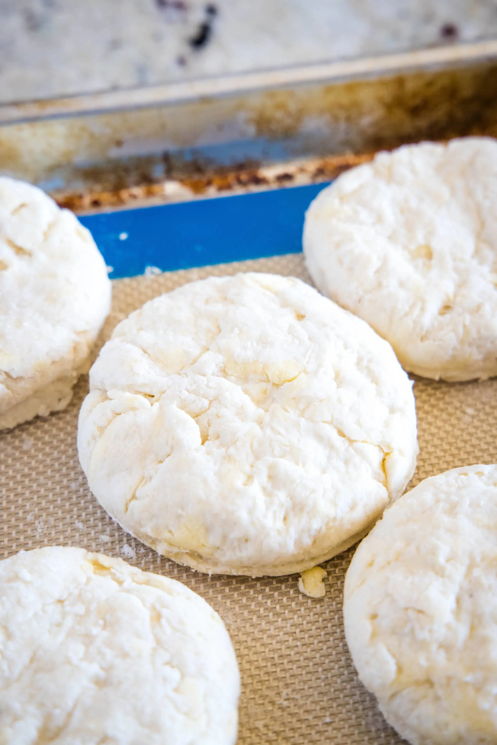 cut biscuit dough on baking tray