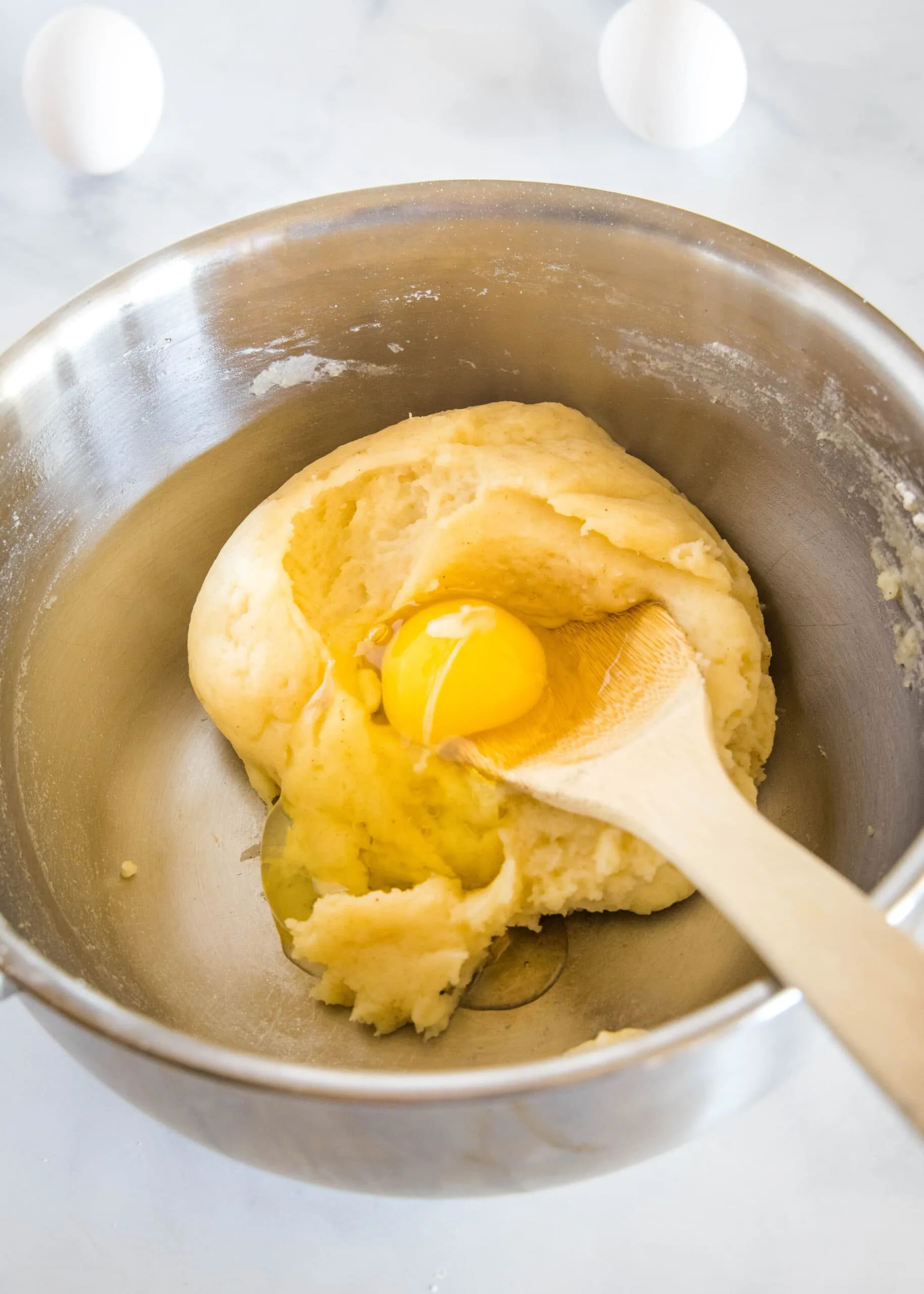 first egg being added to batter