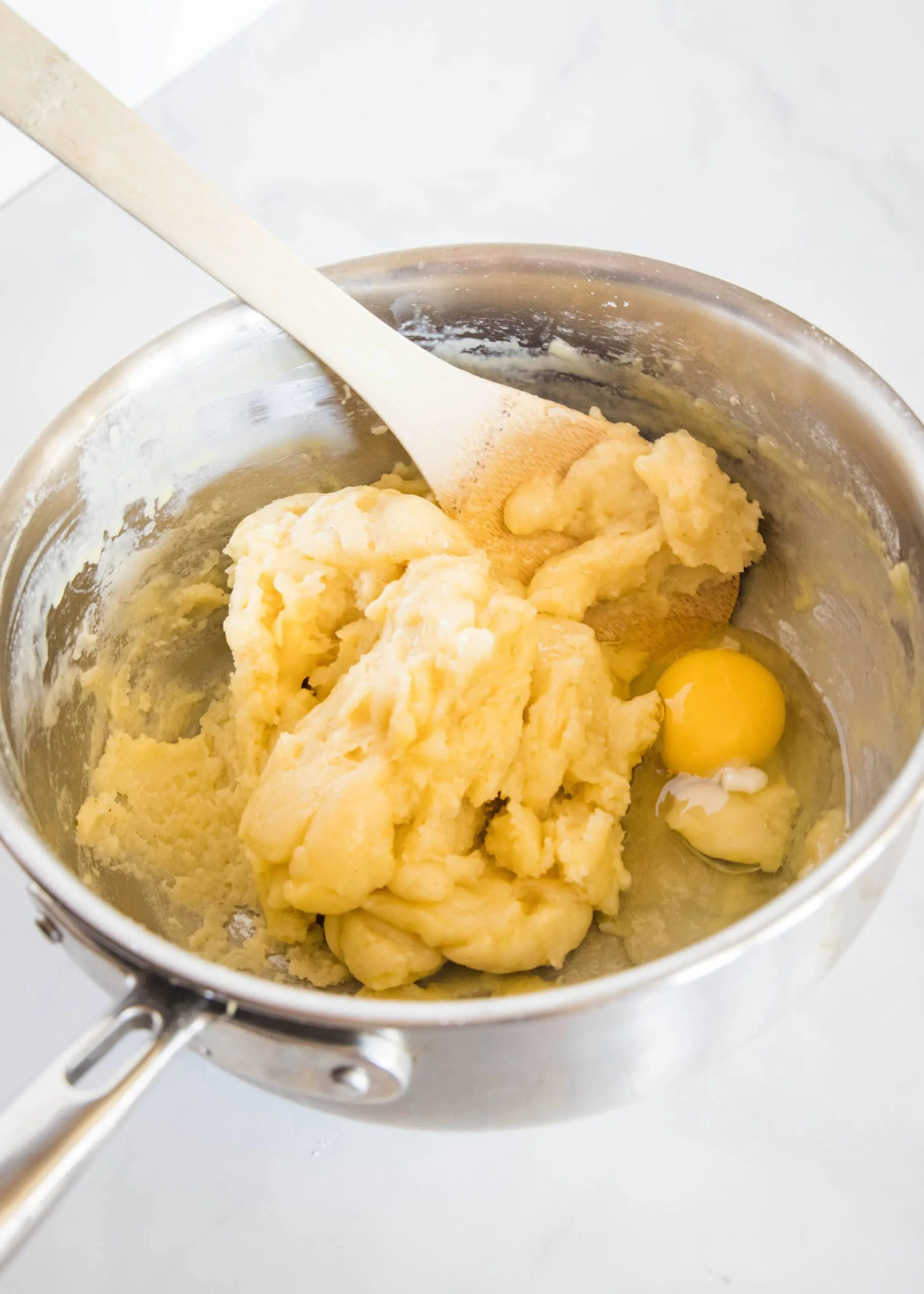 second egg being stirred into dough