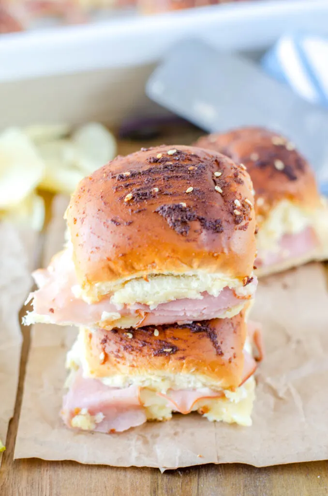 ham and swiss sliders stacked on board