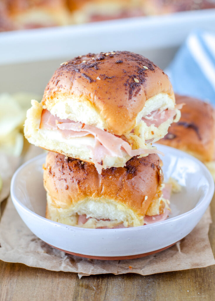 ham and cheese sliders stacked on a plate