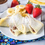 close up of crepes filled with nutella on a plate
