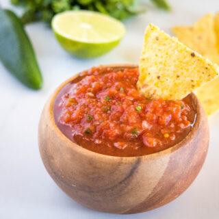 close up of salsa in bowl with chip
