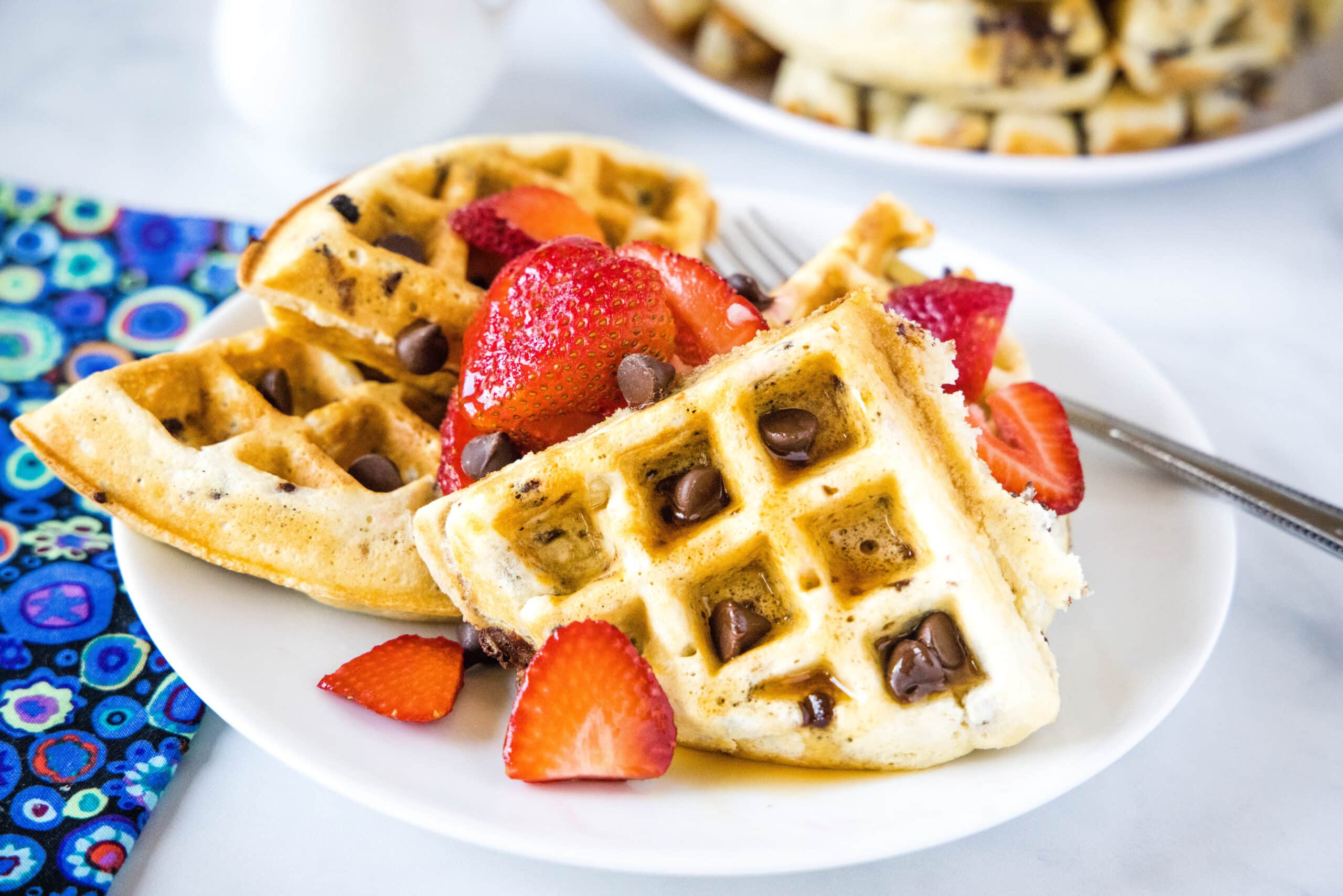 Chocolate Chip Waffles - Light and fluffy waffles full of chocolate chips. The perfect sweet breakfast treat topped with fruit, syrup or even whipped cream!