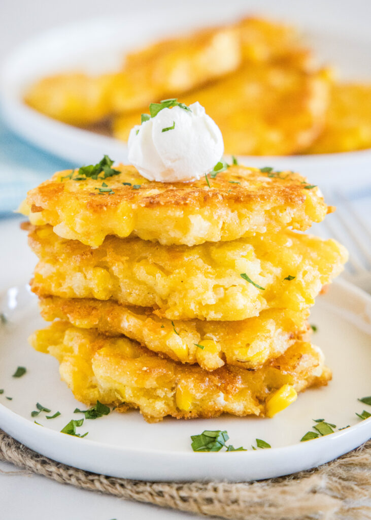 looking at a stack of corn fritters on a plate