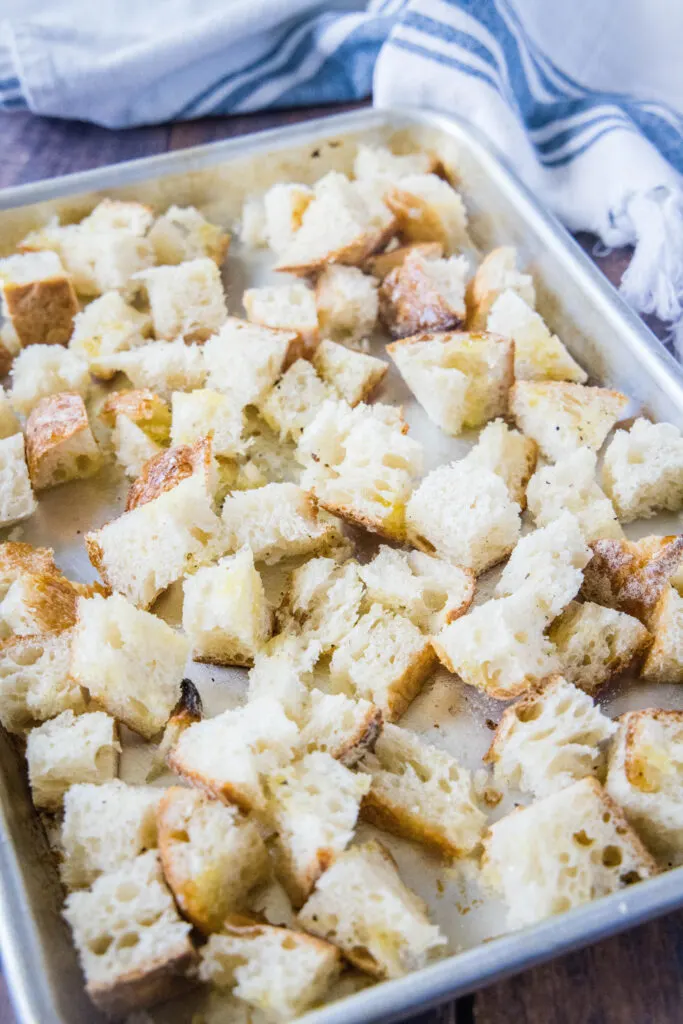 bread cubes tossed with oil and salt and pepperon baking tray