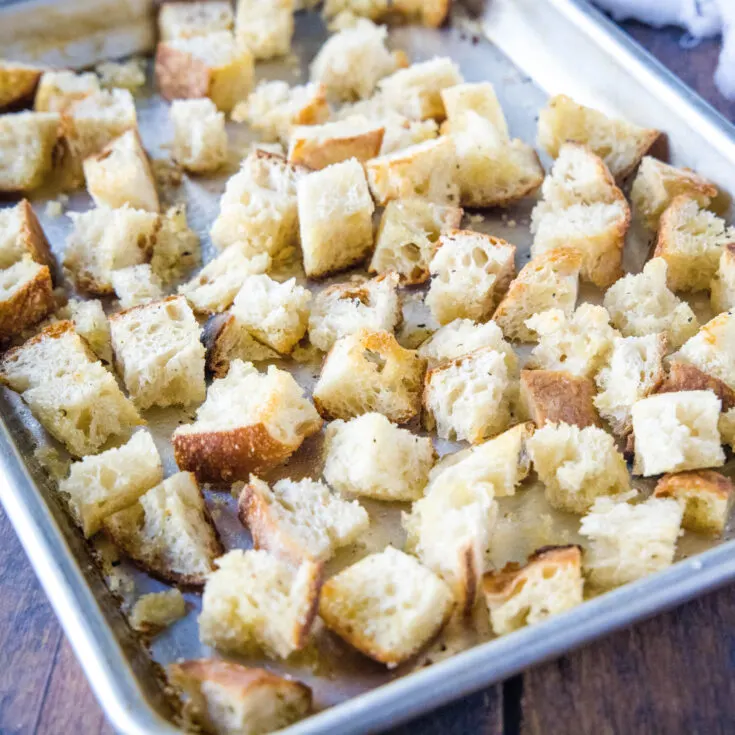 close up of bread cubes on a baking tray