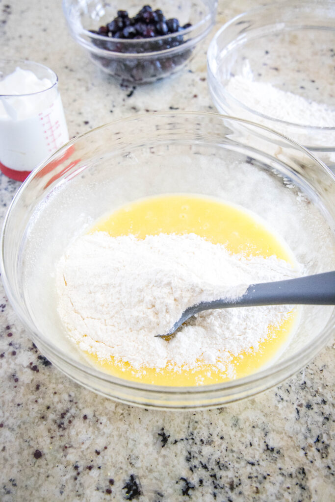 adding flour to lemon cake