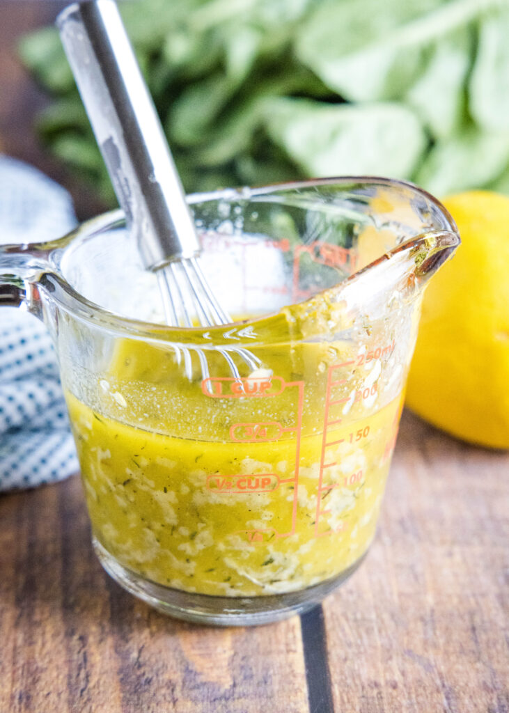 lemon dressing in liquid measuring cup