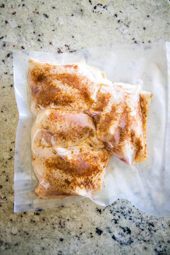 chicken thighs seasoned in a vacuum sealed bag