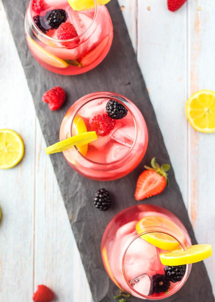looking down on glasses of berry lemonade on a tray