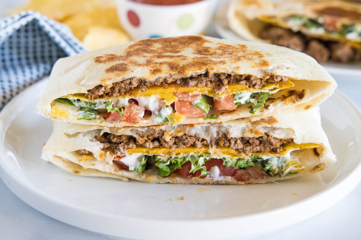 This homemade Crunchwrap Supreme is easier than a drive-thru run and SO much better than Taco Bell. Seasoned beef, nacho cheese, crispy tostada, and fresh toppings — all wrapped up and grilled golden. Ready in 30 minutes!