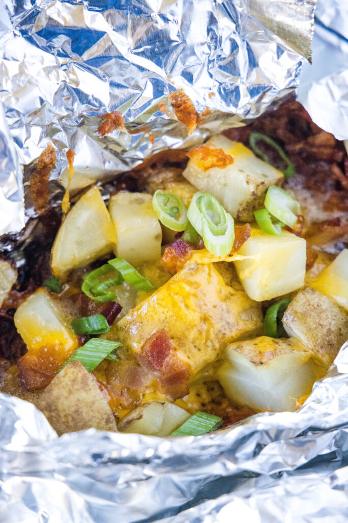 open foil pack with potatoes cooked inside