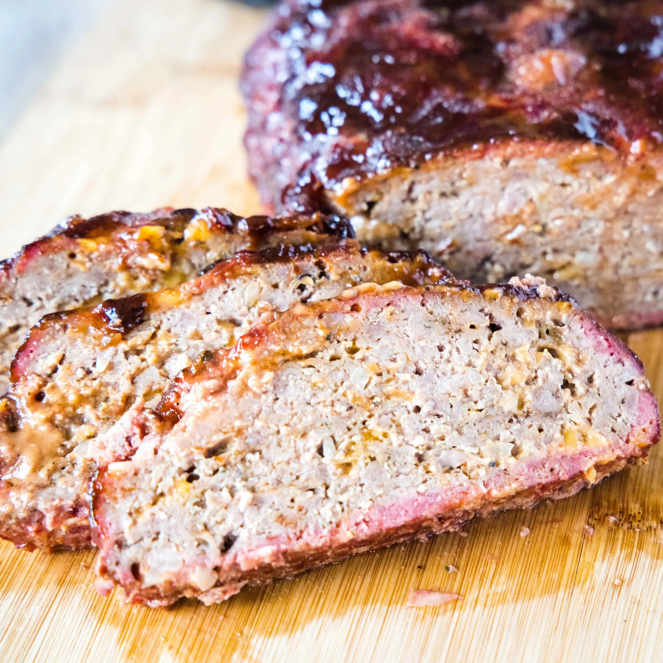 close up sliced meatloaf on a cutting board