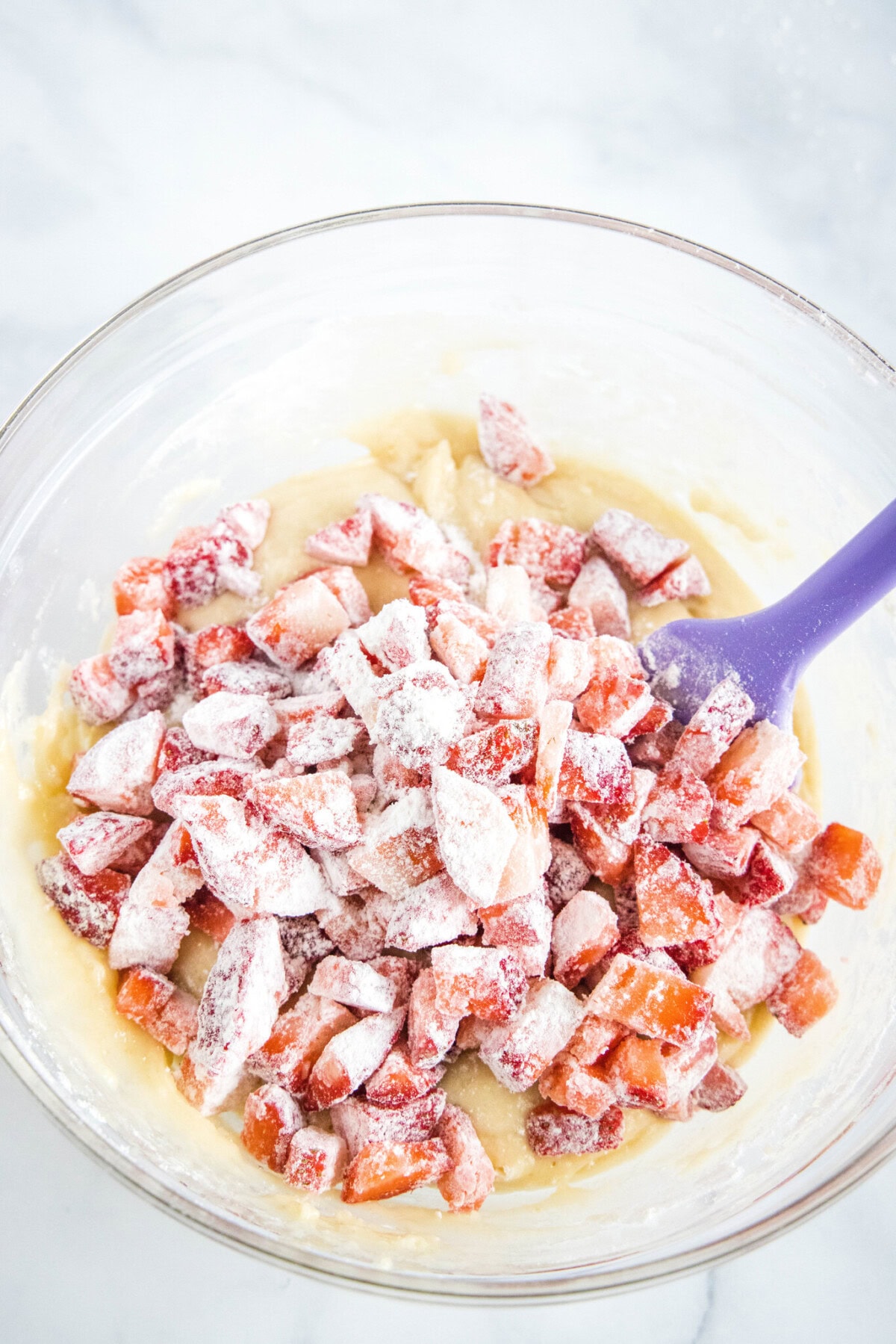 adding strawberries to the batter