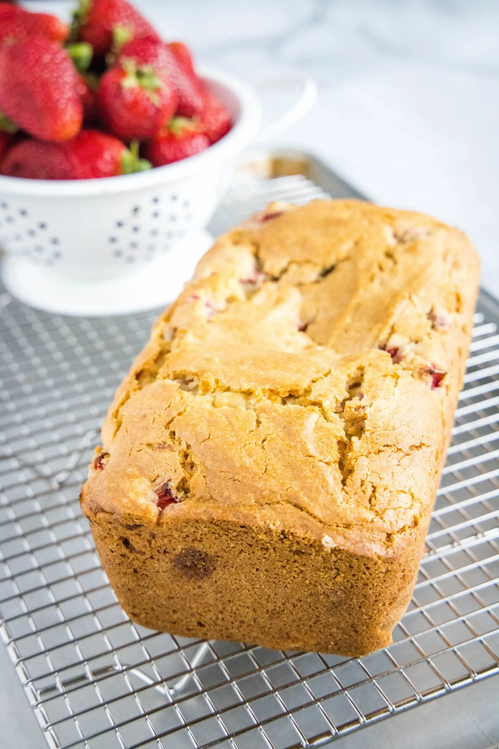 loaf of strawberry bread on cooling rack