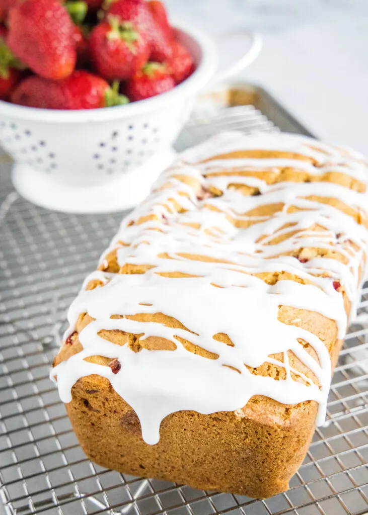 strawberry bread on cooing rack with glaze