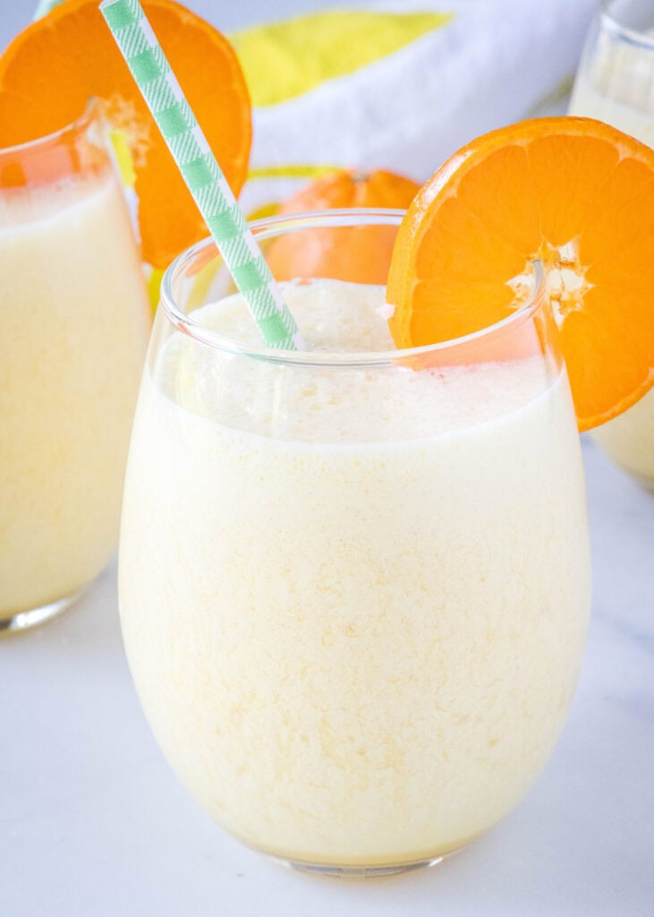 a glass of copycat orange julius with an orange slice