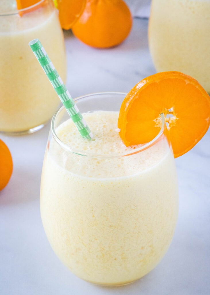 orange julius copycat in a glass with a straw