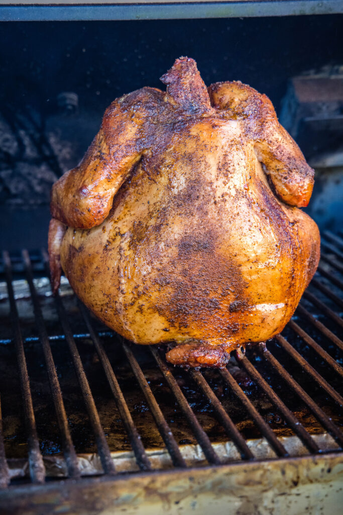 cooked whole chicken on the smoker
