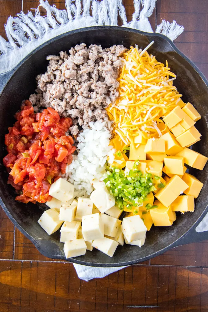 ingredients for queso in cast iron skillet