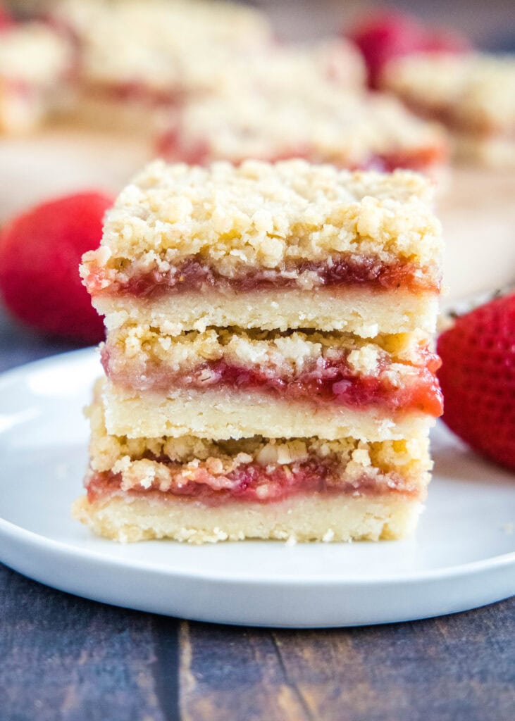 strawberry streusel bars stacked on a plate