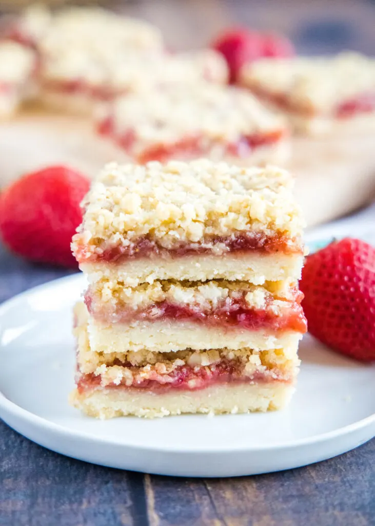 stacked strawberry bars on a plate