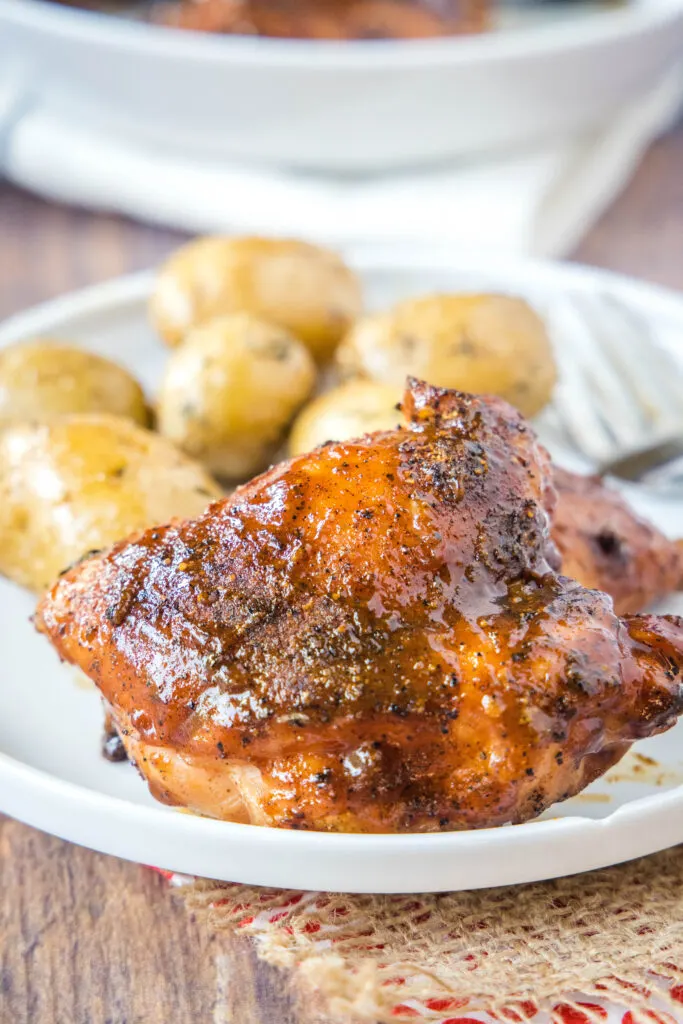 smoked chicken thigh on a plate with potatoes