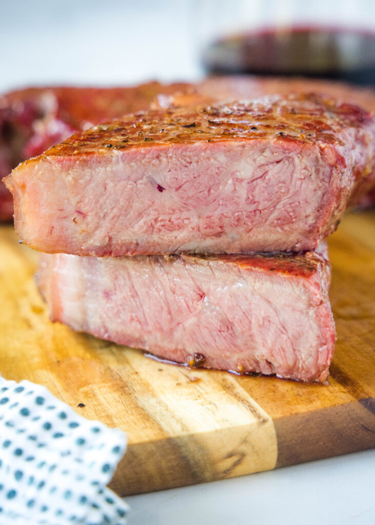 a steak cut in half on a cutting board