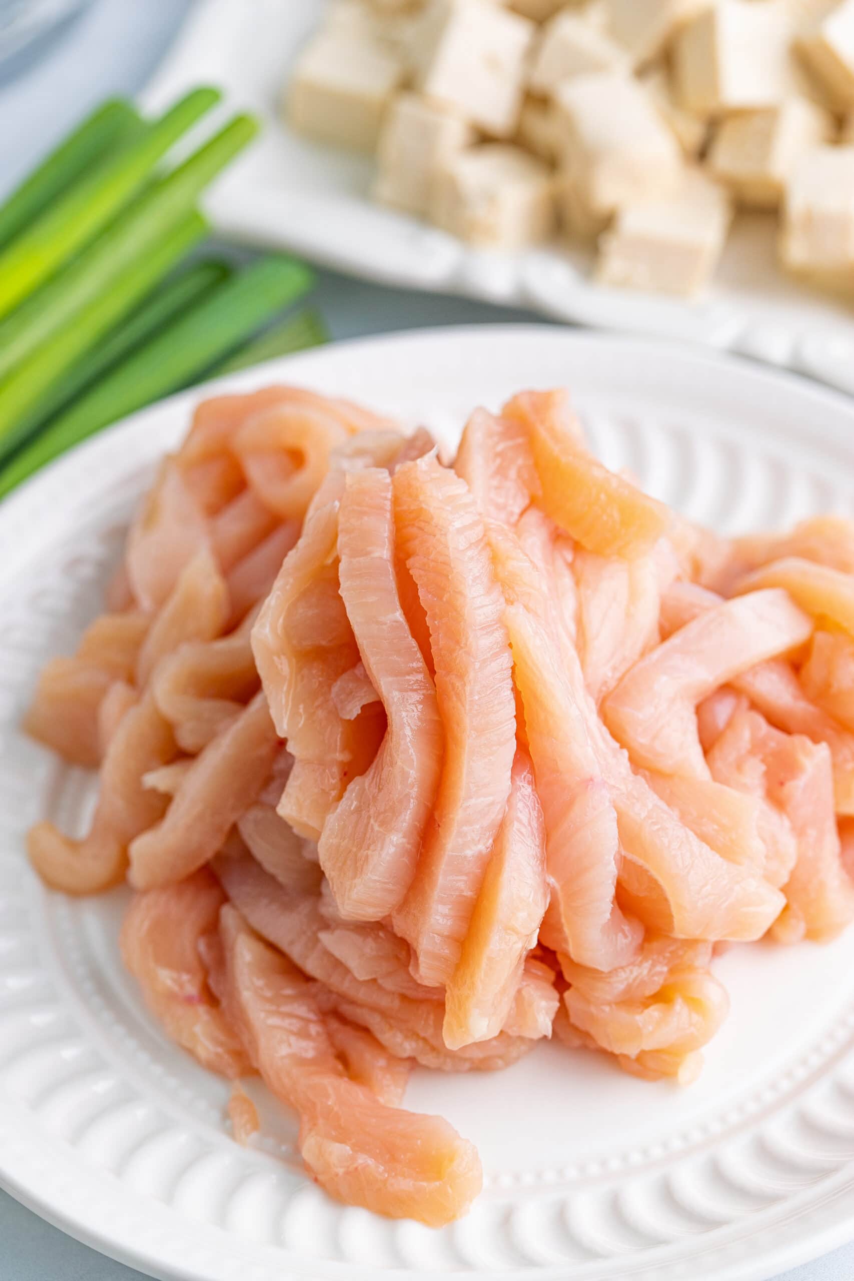 raw chicken strips on a plate