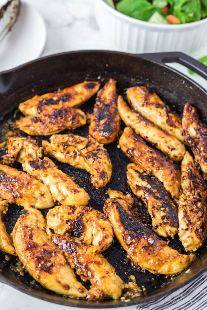 chicken tenders cooking in a skillet